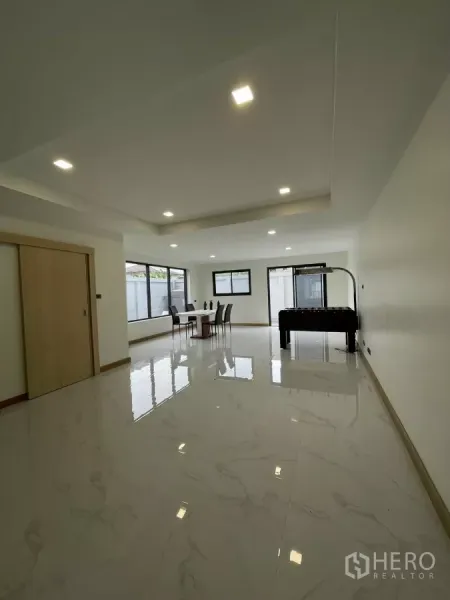 Home Office for rent in Khan Na Yao, Bangkok - Spacious ground-floor open-plan area with glossy tiles, large windows and recessed lighting.