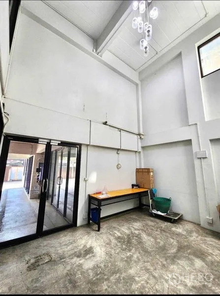 Office Space for rent or sale in Din Daeng, Bangkok - Tall lobby workspace with glass entry doors, workbench, and pendant lights.
