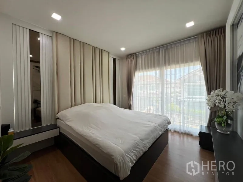 Detached House for rent or sale - Master bedroom with large windows, sheer curtains and wood flooring.