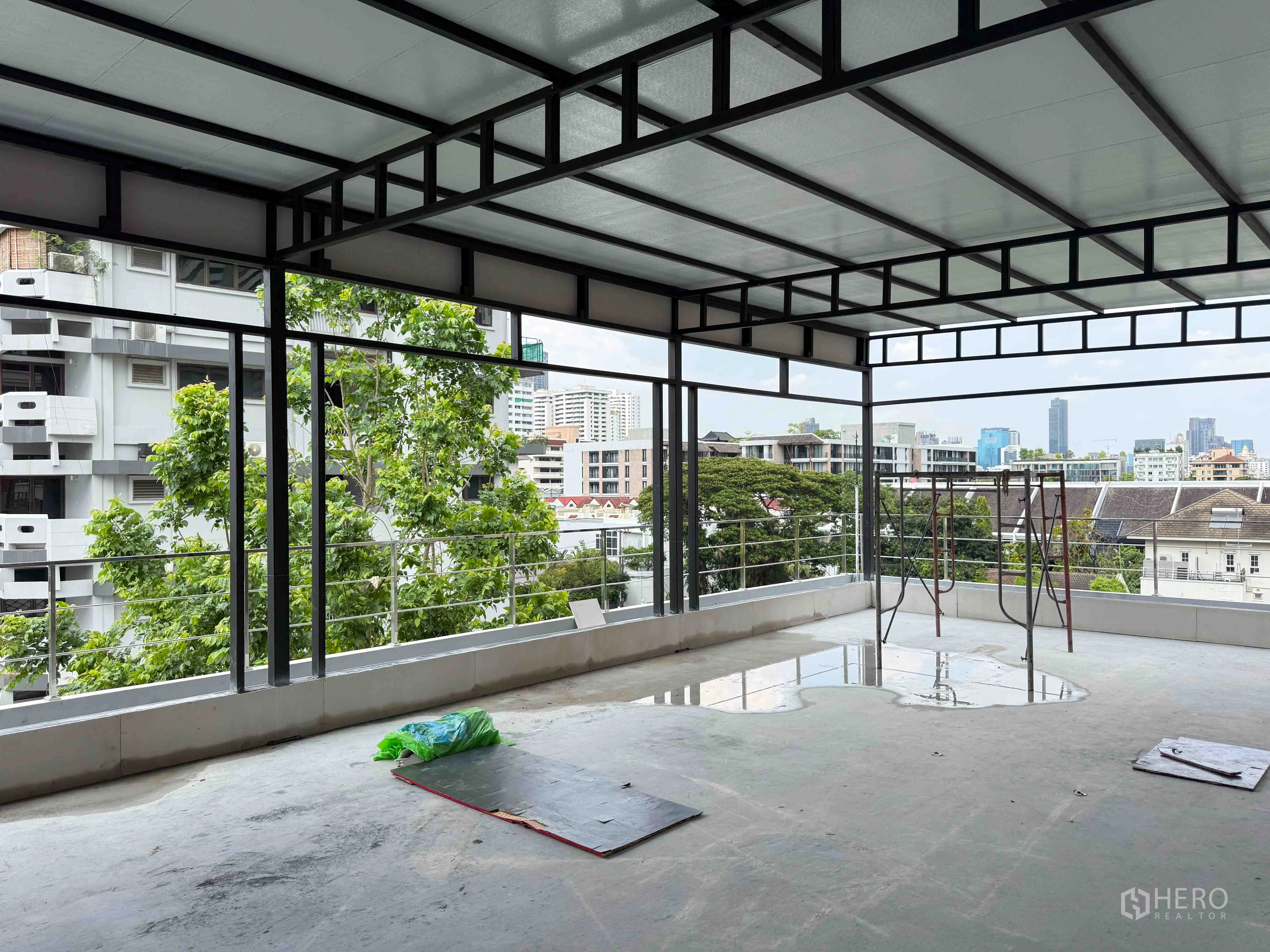Retail Space for rent in Watthana, Bangkok - Covered terrace level with metal frame and city and tree views.