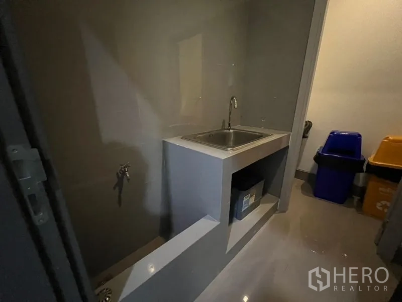 Office Space for rent - Compact pantry with a stainless-steel sink and built-in counter.