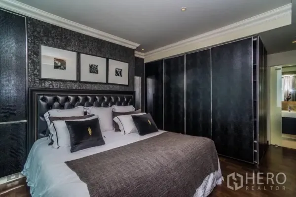 คอนโด ให้เช่าหรือขายในKhlong Toei, Bangkok - ห้องนอนมาสเตอร์ เตียงหัวบุหนัง ตู้เสื้อผ้าลายเท็กซ์เจอร์ และกรอบรูป