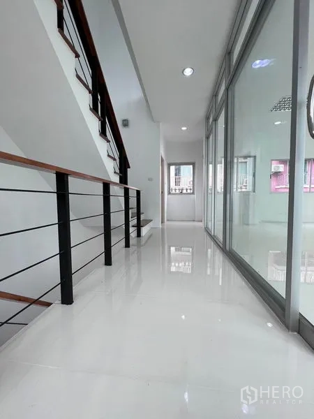 Home Office for sale in Lat Krabang, Bangkok - Bright corridor with glossy white flooring and glass-partitioned office rooms.