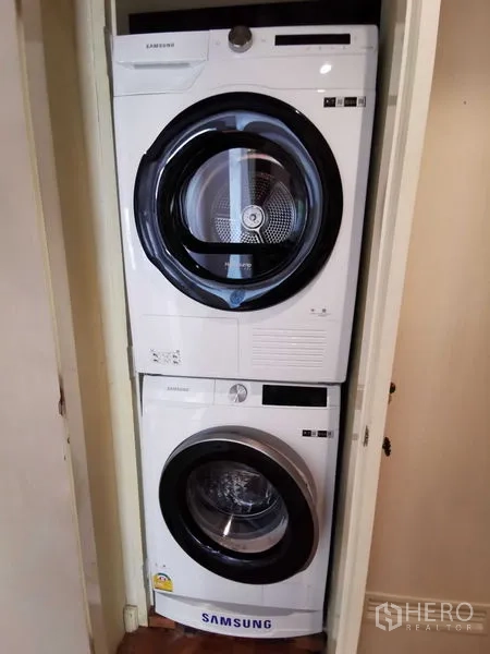 Condominium for rent in Pathum Wan, Bangkok - Stacked Samsung washer and dryer in a laundry closet.