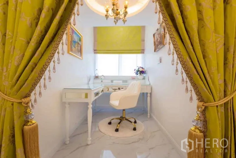 Townhouse for rent in Lat Phrao, Bangkok - Bright study nook with white desk and chair framed by green tassel curtains.