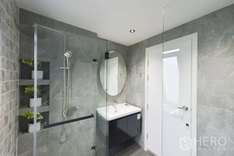 Home Office for rent or sale - Contemporary bathroom with glass shower enclosure and round mirror.