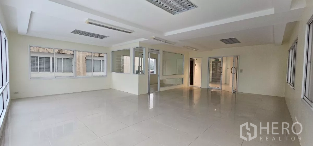 Office Space for rent in Bueng Kum, Bangkok - Spacious office room with windows on two sides and an internal glass office.