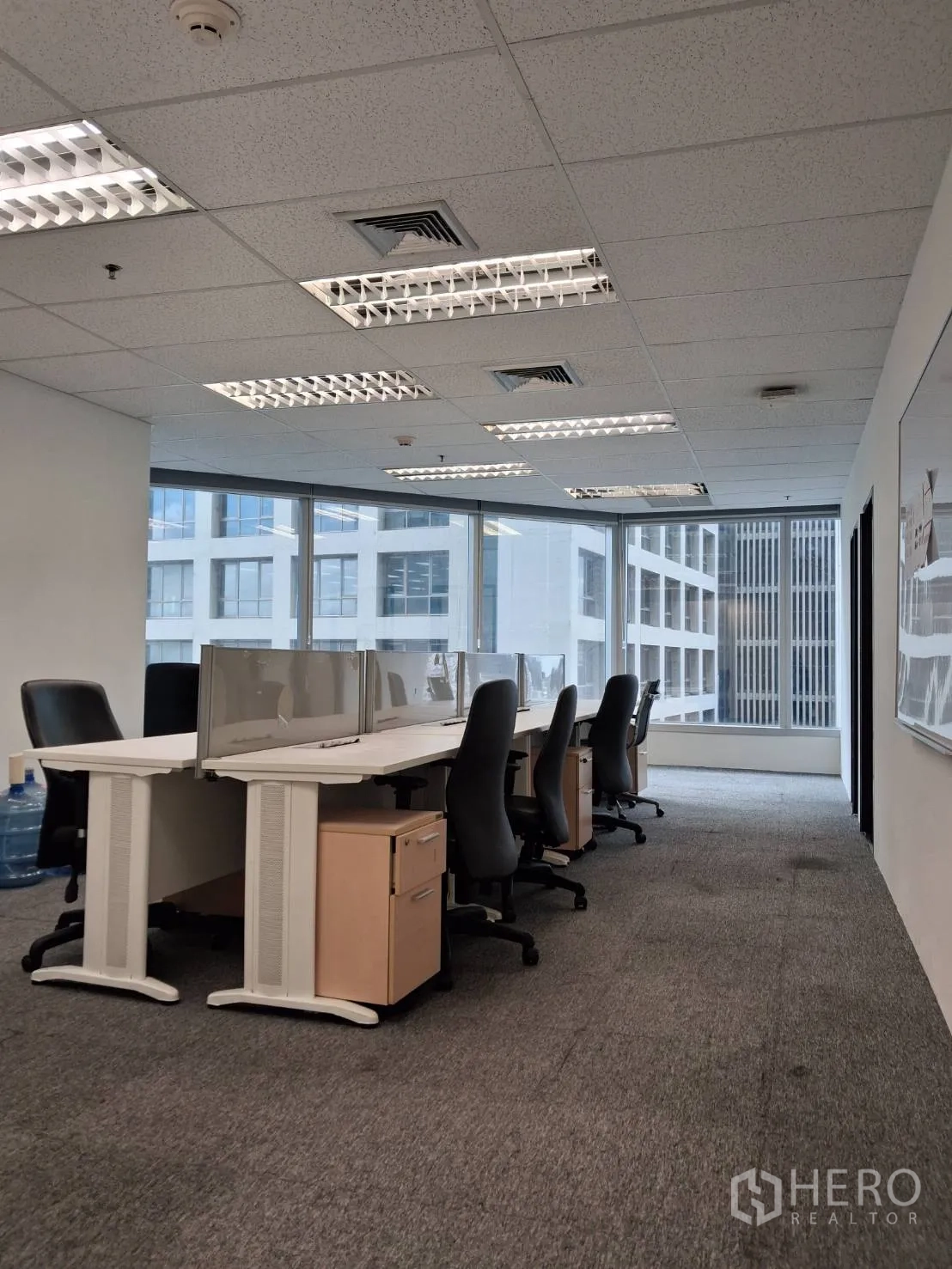 Office Space for rent in Sathon, Bangkok - Spacious open workspace with shared desks, pedestals and corner glazing overlooking towers.