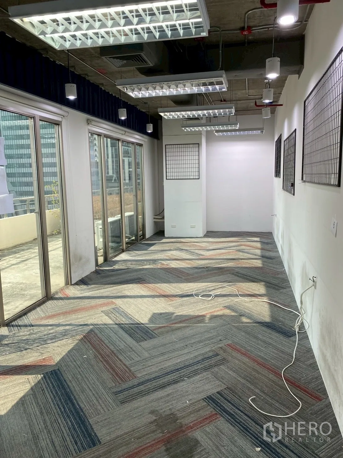 办公室 for rent in Watthana, Bangkok - 狭长房间，推拉玻璃门通往室外露台。