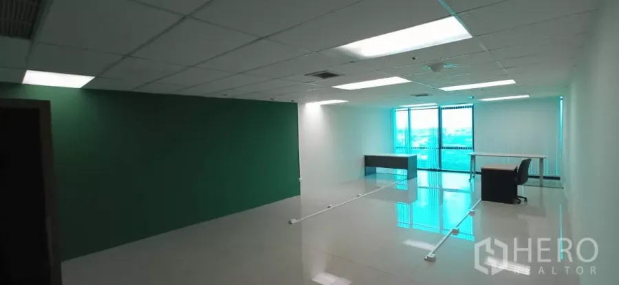 Office Space for rent in Huai Khwang, Bangkok - Open-plan 90 sqm office with green accent wall, drop ceiling lights and full-height windows in Huai Khwang.