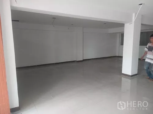 Shophouse for rent in Bang Rak, Bangkok - Ground-floor open-plan retail space with white walls and glossy tiled flooring.