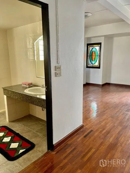 Home Office for rent - Hallway featuring a granite bathroom vanity and a colorful stained glass window.