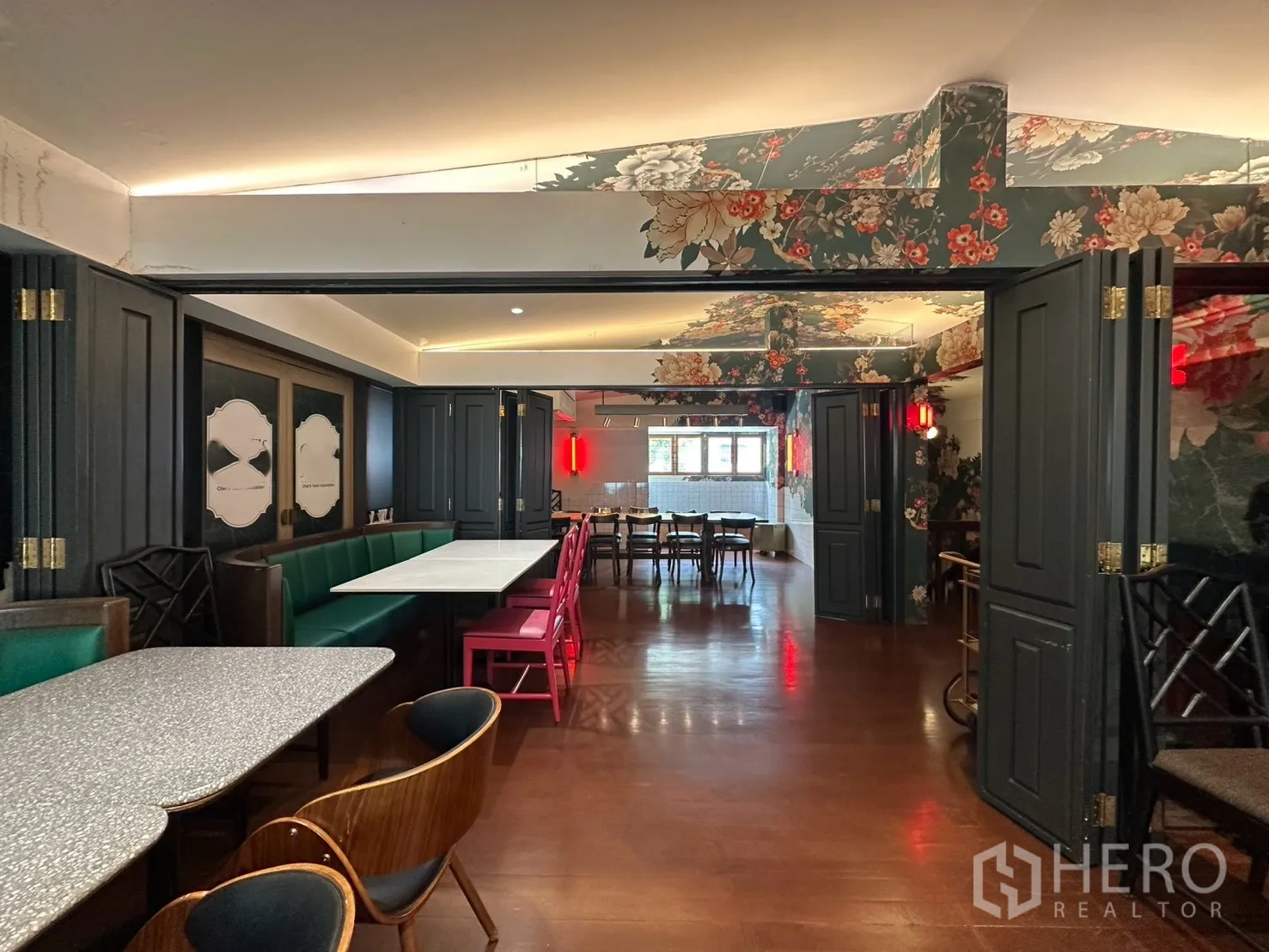 Detached House for rent in Watthana, Bangkok - View through partitioned rooms with banquette seating and wood floors.