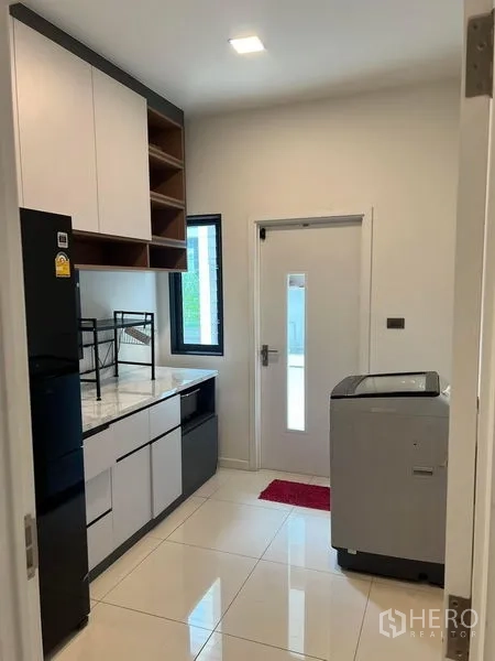 Detached House for rent or sale - Kitchen worktop with window and rear door, space for laundry.