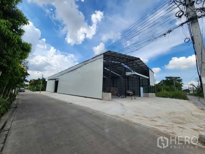 Warehouse for rent in Pak Kret, Nonthaburi - Modern steel-frame warehouse with large concrete yard on a quiet road in Pak Kret.