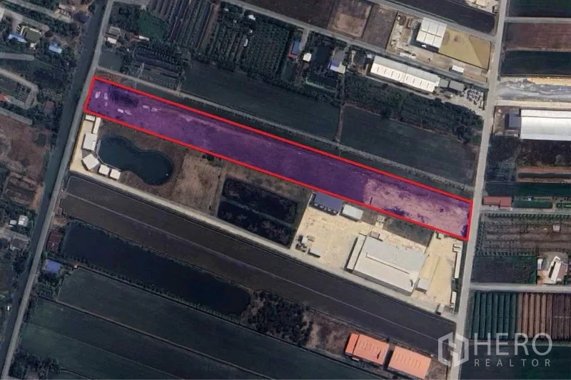 Land for sale in Sai Noi, Nonthaburi - Aerial view of a long rectangular land parcel outlined in red amid farms and factories.