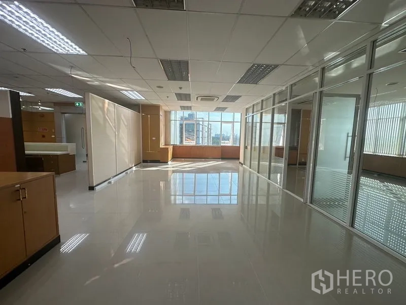 Office Space for rent in Suan Luang, Bangkok - Open office zone facing glass partitions with a sunlit windowed end.