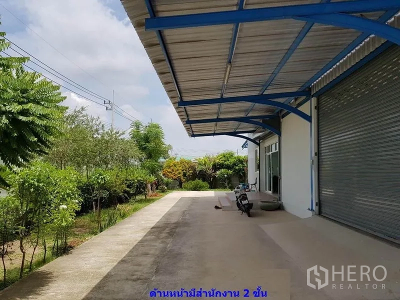 โรงงาน ให้เช่าในSamut Sakhon - ลานหน้าพร้อมกันสาดและทางรถเข้า ข้างสวนต้นไม้