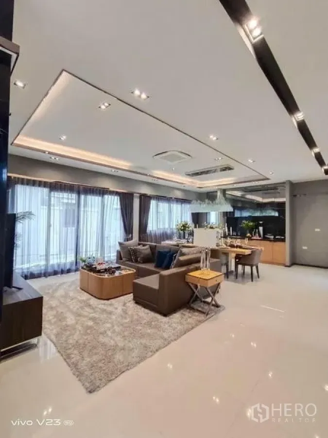 Detached House for sale in Wang Thonglang, Bangkok - Open-plan living and dining area with recessed ceiling lights and expansive windows.