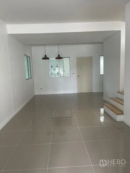 Townhouse for sale - Open-plan living and dining area with glossy tiles and two pendant lights