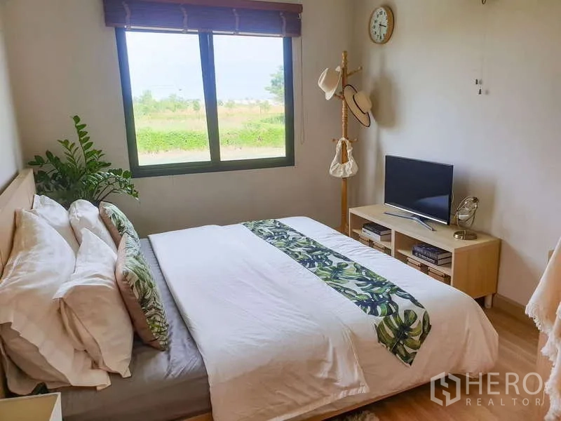 Detached House for sale in Bang Phli, Samut Prakan - Bright bedroom with garden-view window, TV stand and queen bed