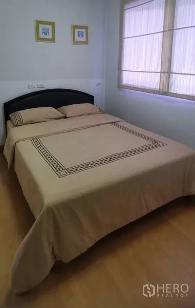 Condominium for rent in Watthana, Bangkok - Second bedroom with double bed, soft lighting, and window.