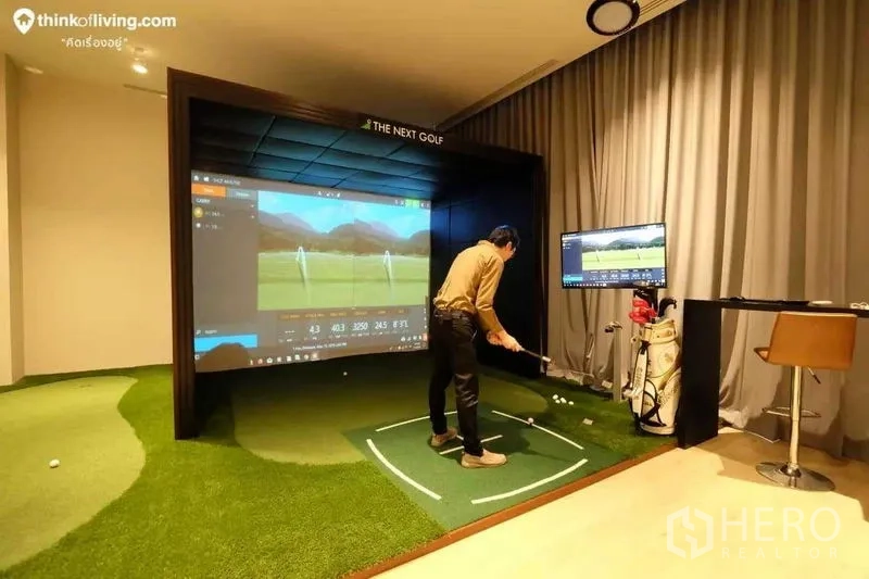 Condominium for rent in Watthana, Bangkok - Indoor golf simulator bay with large projection screen and putting green