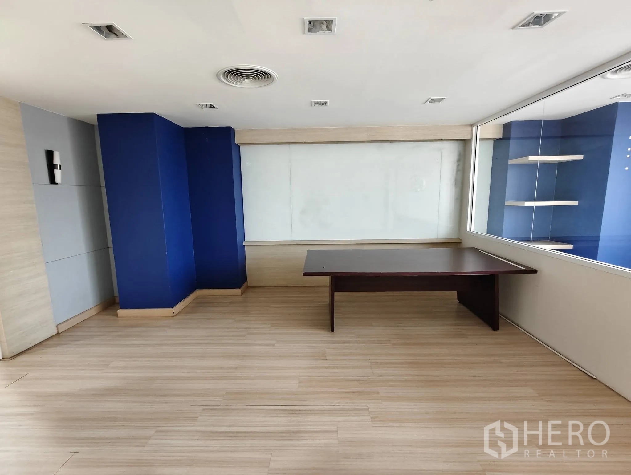 Office Space for rent in Lak Si, Bangkok - Meeting room with blue columns, glass partition, and wall whiteboard.