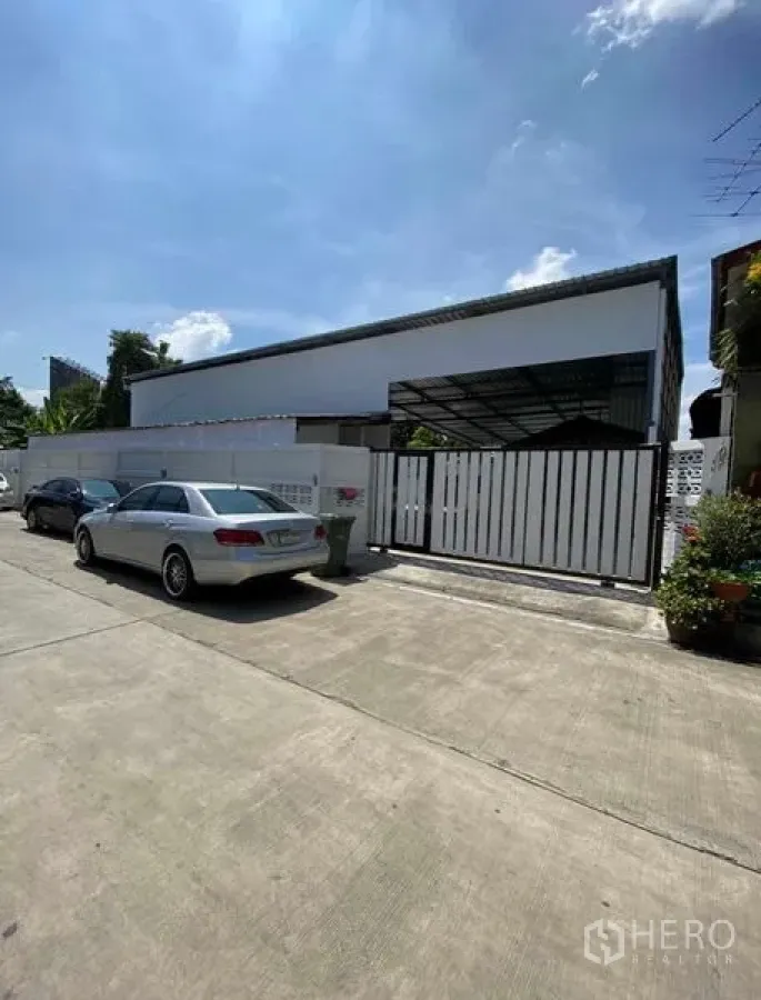 货栈 出租在Bang Khen, Bangkok - 街景正门，滑动金属大门与路边停车