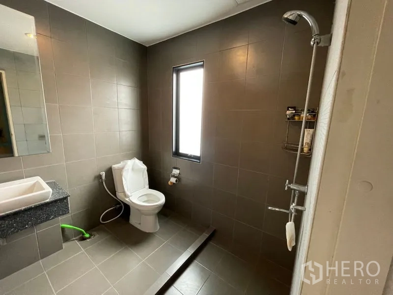 Home Office for sale - Modern bathroom with walk-in shower, gray tiles and slim frosted window.