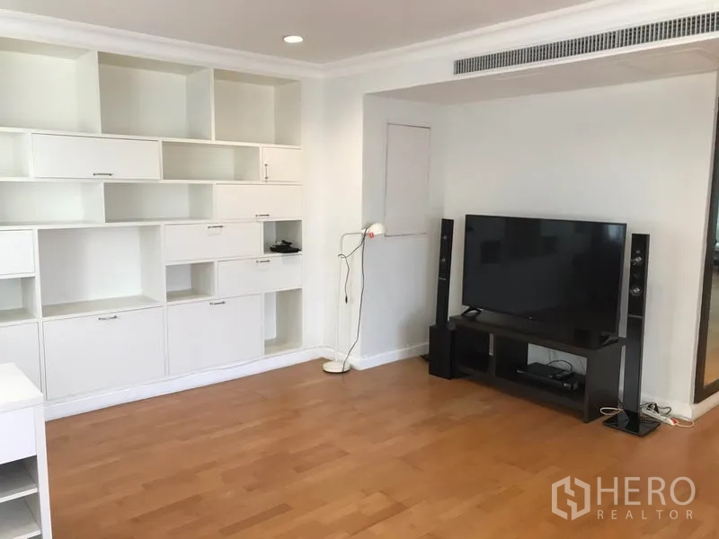 Condominium for rent in Sathon, Bangkok - TV corner with media console, speakers and custom shelving.