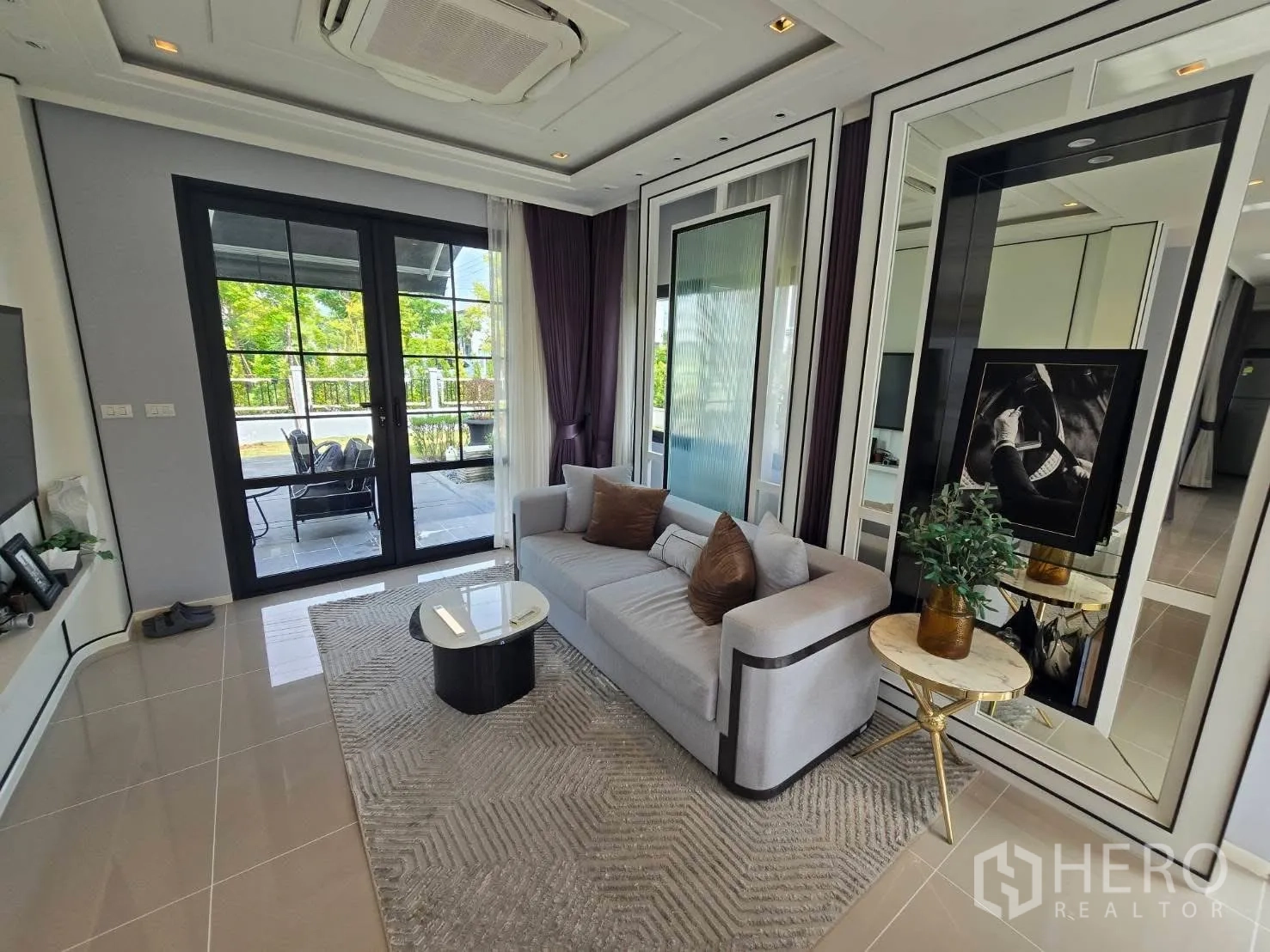 Semi-detached House for rent in Bang Phli, Samut Prakan - Bright living room with sofa, glass doors to patio, and mirrored wall panels.