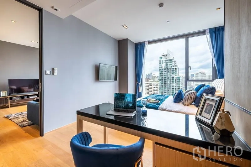 Condominium for rent or sale in Khlong Toei, Bangkok - Workstation by full-height window with skyline view connected to the bedroom.