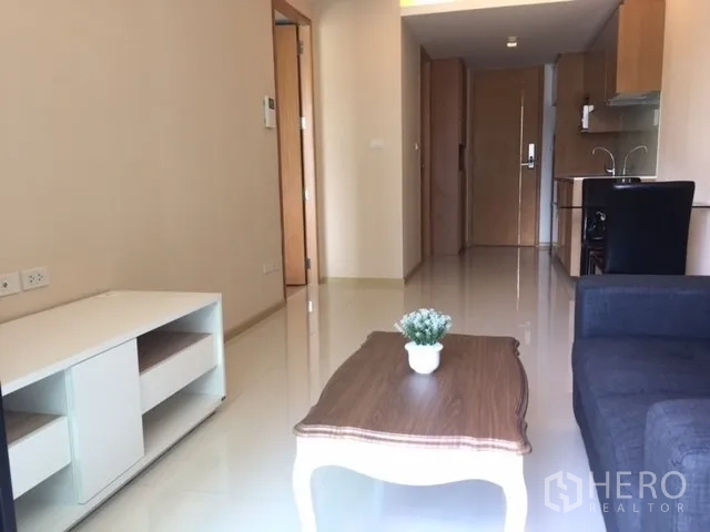 คอนโด ให้เช่าหรือขายในPathum Wan, Bangkok - ห้องนั่งเล่นและครัวแบบเปิดสว่างพื้นเงา พร้อมประตูกระจกออกระเบียง