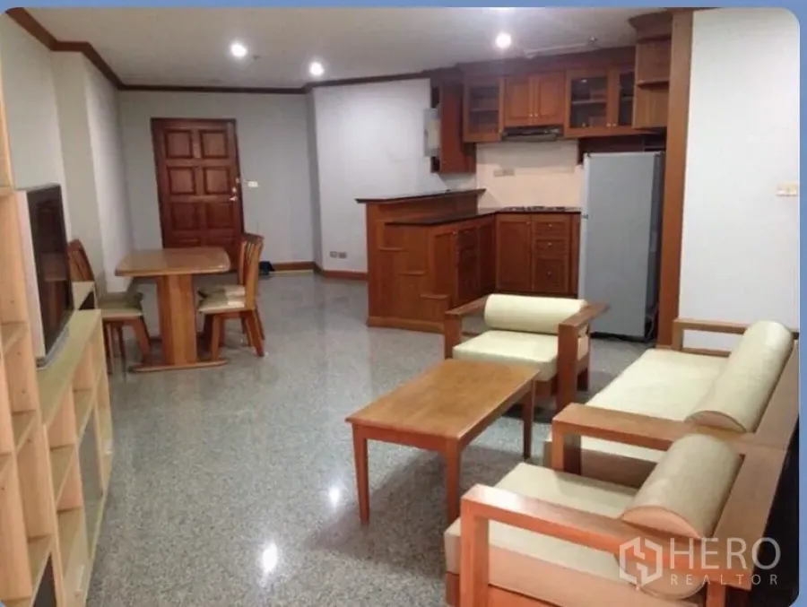 Condominium for rent in Ratchathewi, Bangkok - Open-plan living, dining and kitchen area with built-in wood cabinetry