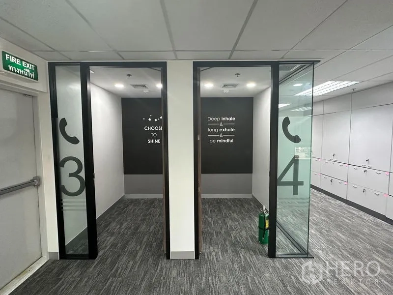Office Space for rent in Khlong Toei, Bangkok - Two compact phone booths with glass doors and motivational wall text.