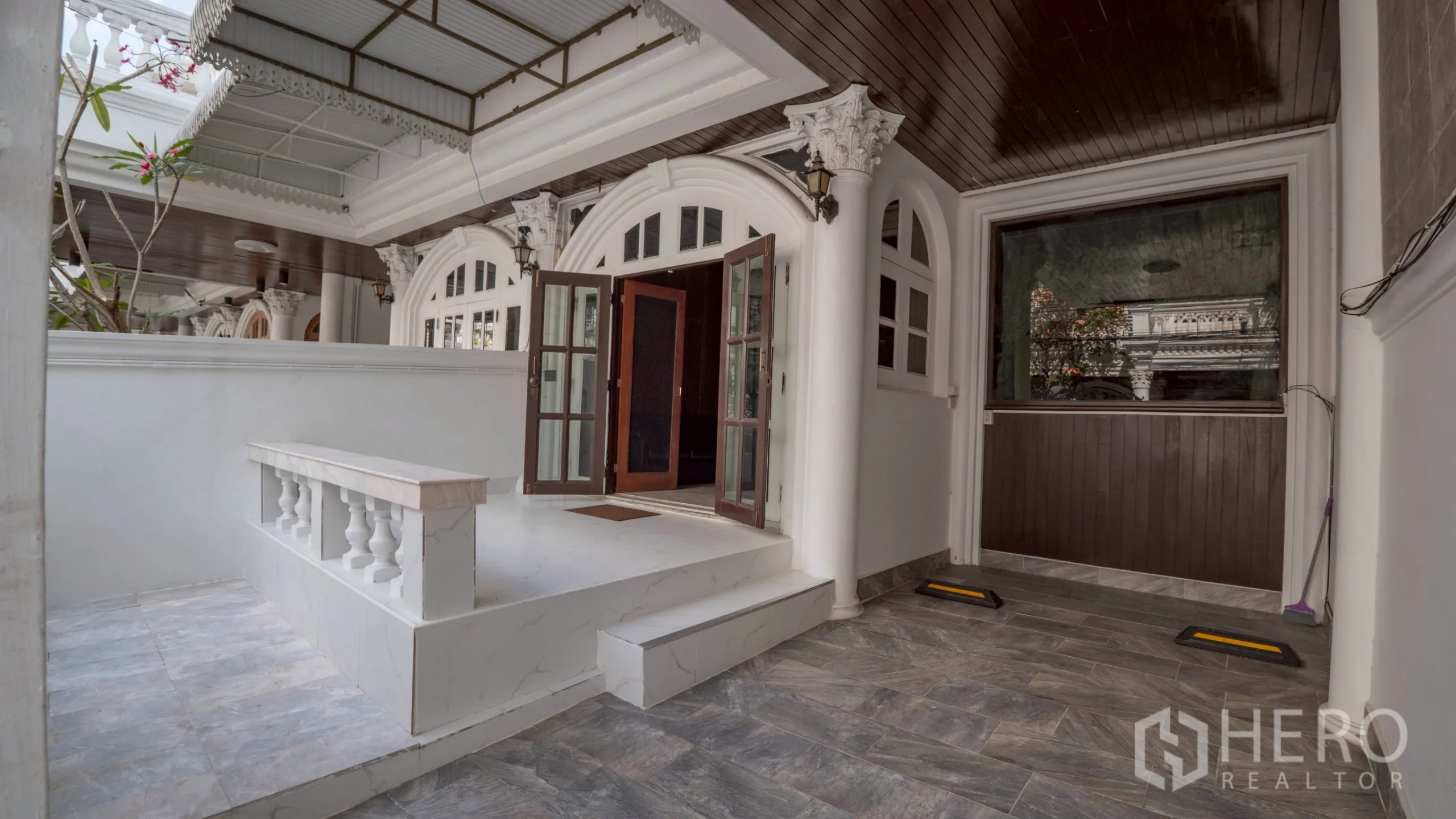 Townhouse for rent in Khlong Toei, Bangkok - Covered front porch and carport with classical columns and arched doorway.