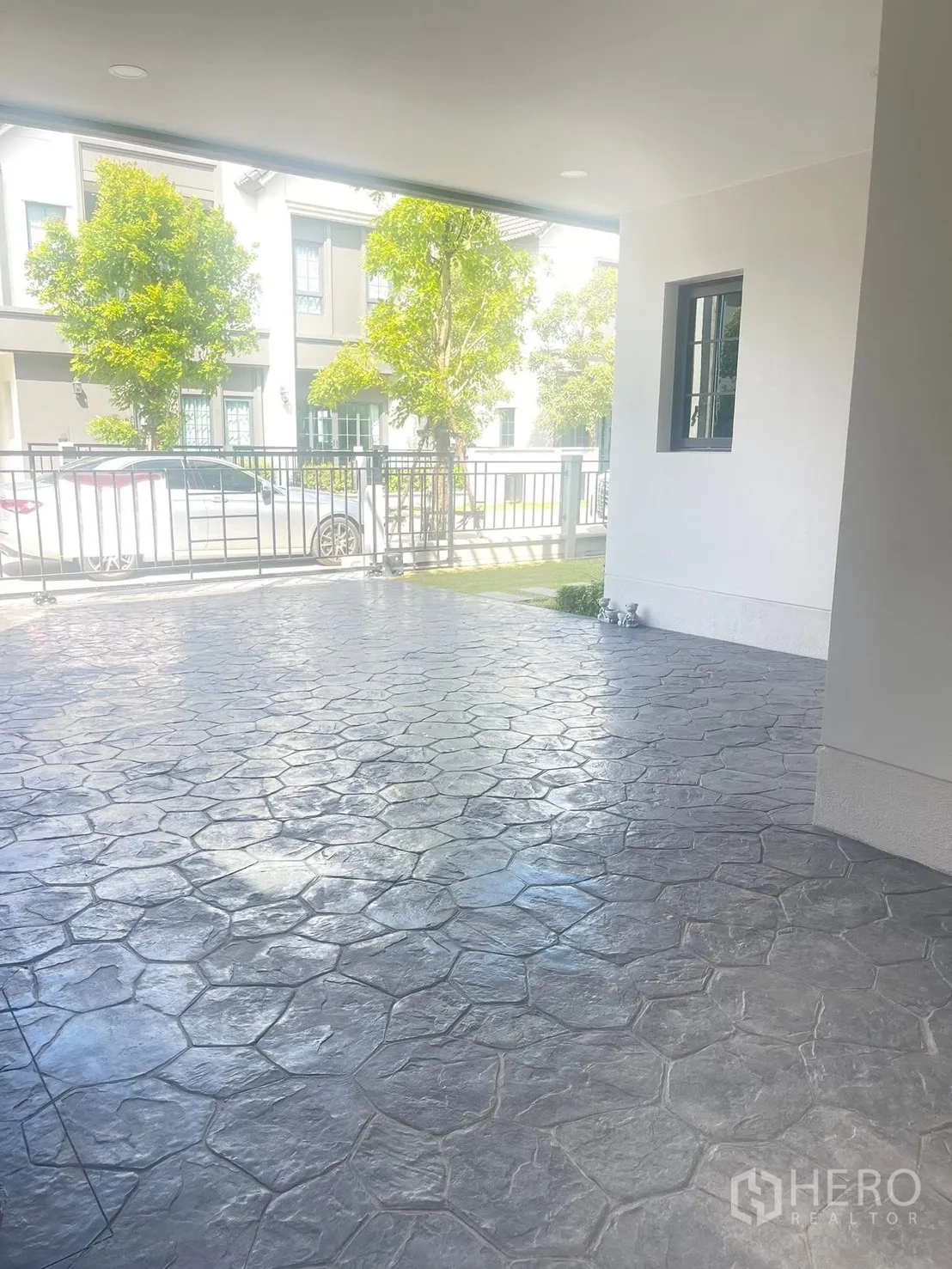 Detached House for rent in Bang Phli, Samut Prakan - Covered carport with stamped concrete flooring in a gated community.