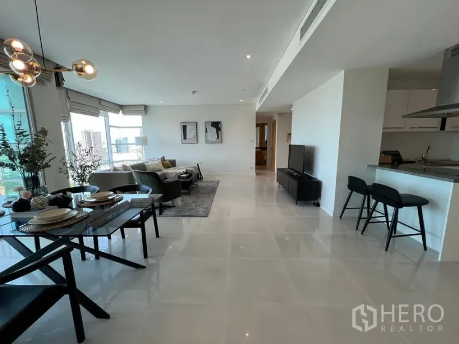 Condominium for rent in Watthana, Bangkok - Open‑plan living, dining and kitchen with glossy floors, breakfast bar and city views.